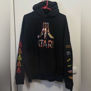 Atari Men’s Black Hoodie Sweatshirt Video Game Cover Logos Sleeve Hits Size XL